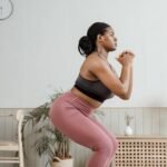 An image of a woman doing squats at home