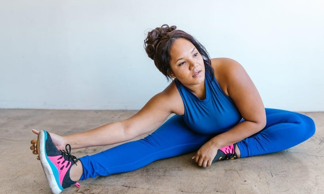 An image of a woman warming up before an online workout class