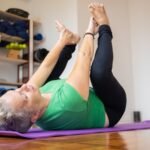 An image of woman stretching her hips and glutes before for mobility training