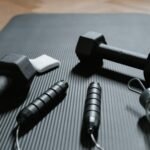 Dumbbells and a Jumping Rope on a Yoga Mat