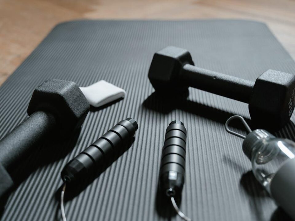 Dumbbells and a Jumping Rope on a Yoga Mat