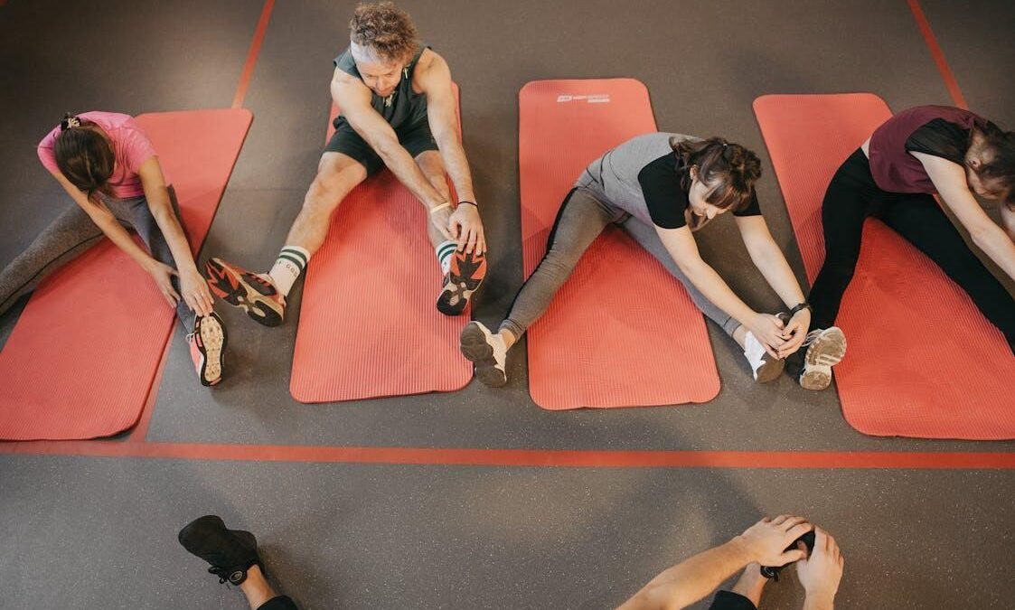 A group of women exercising together in a bright studio.