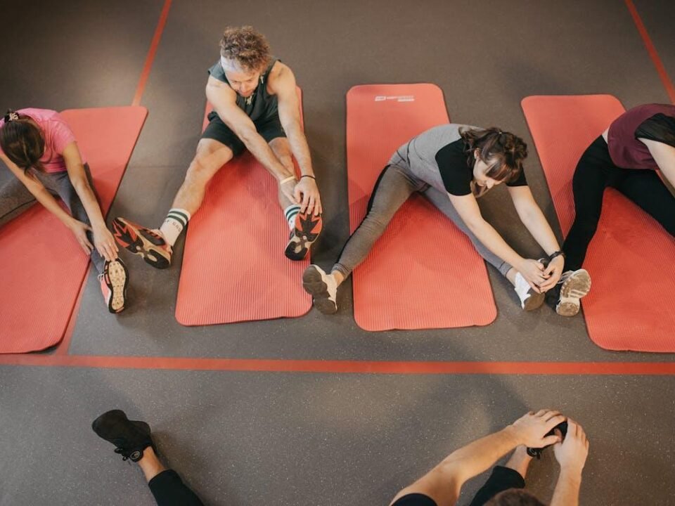 A group of women exercising together in a bright studio.