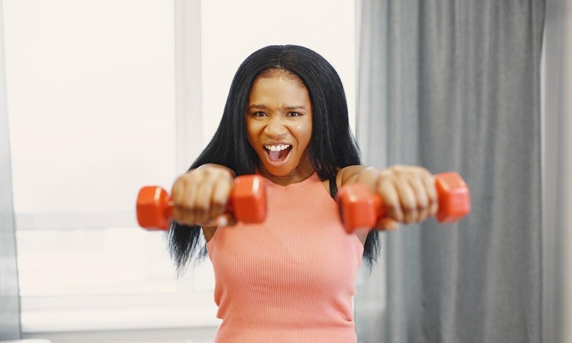 Woman performing dumbbell exercise at home, focusing on upper body strength training